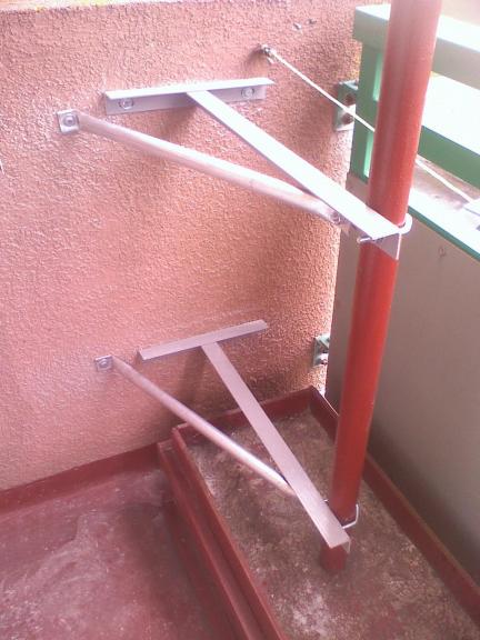 Balcony mounted brackets - twin braced Ts & concreted base.